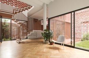 Ampio e luminoso ingresso open space con parquet, grandi finestre e scale che conducono al piano superiore