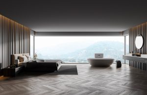 Un salotto minimale con parquet con una grande finestra orizzontale che prende un'intera parete e si affaccia su un panorama montano