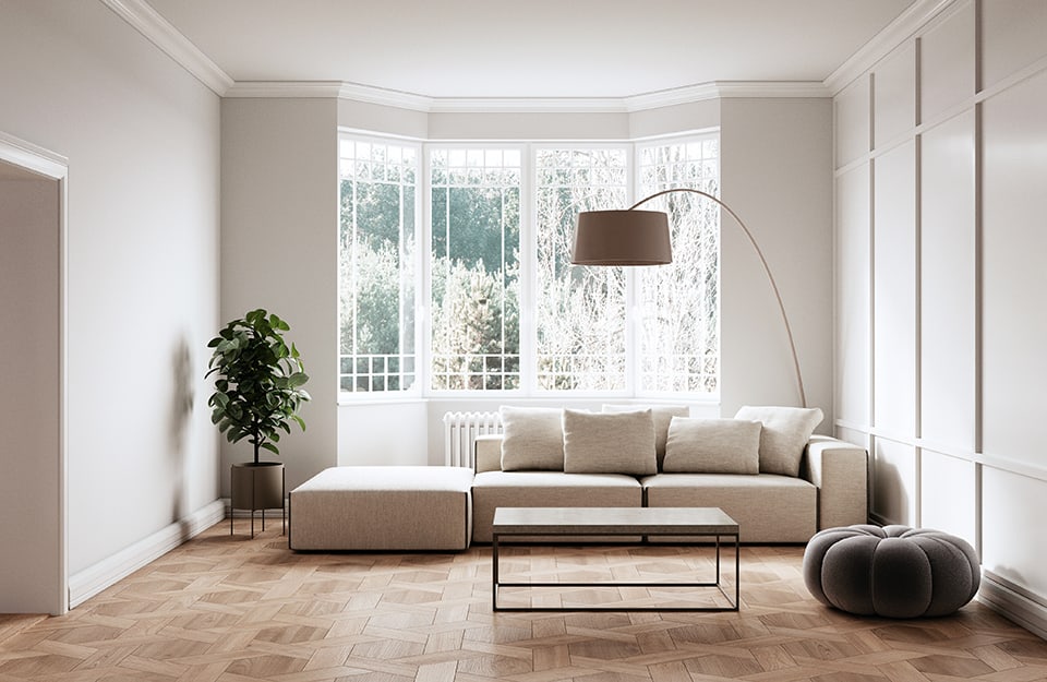 Una salotto moderno dallo stile minimale tutto sui toni del bianco e del legno naturale, con parquet con disegni geometrici esagonali