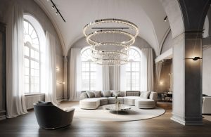 Grande salotto con soffitti a volta ed enorme lampadario moderno a spirale, con sofà semicircolare, poltrona, grande tappeto, tavolino da caffè circolare in metallo, pavimento in parquet e tre finestre ad arco