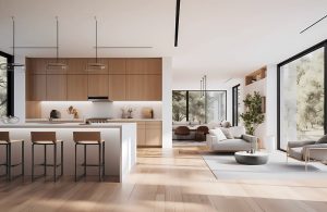 Ampio e luminoso openspace arredato in stile essenziale e moderno sui toni del bianco e del legno naturale, con cucina a vista e isola con sgabelli, salotto e grande finestra che dà su un giardino alberato